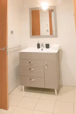 a bathroom with a sink and a mirror at SWEET BCN Plaza Universidad in Barcelona