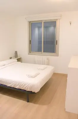 a large bed in a room with a window at SWEET BCN Plaza Universidad in Barcelona
