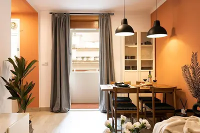 a living room with a table and a dining room at Lodging Apartments Barceloneta Mar in Barcelona