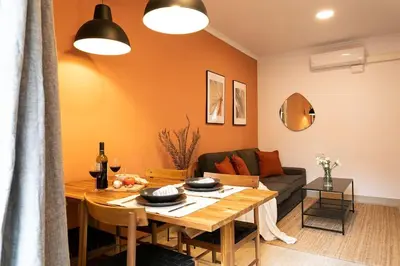 a living room with a table and a couch at Lodging Apartments Barceloneta Mar in Barcelona
