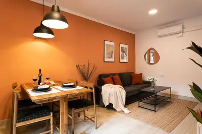 a living room with a couch and a table at Lodging Apartments Barceloneta Mar in Barcelona