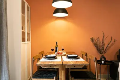 a dining room with a wooden table with wine glasses at Lodging Apartments Barceloneta Mar in Barcelona