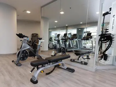 a gym with a bunch of exercise bikes and mirrors at Hilton Diagonal Mar Barcelona in Barcelona