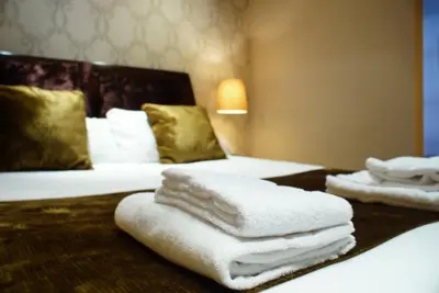 a room with two beds with towels on a table at Casa Boutique Barcelona in Barcelona