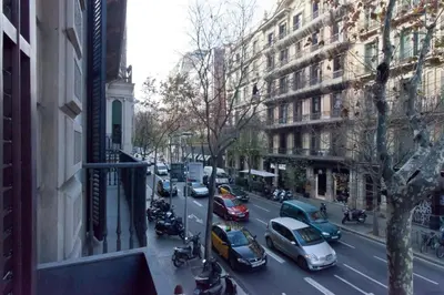 a busy city street with cars and motorcycles on the road at Casa Boutique Barcelona in Barcelona