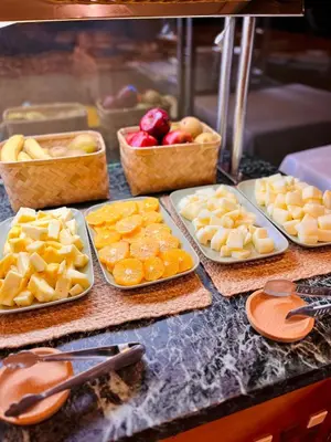 a table with plates of food and baskets of fruit at Ciudad de Castelldefels in Castelldefels