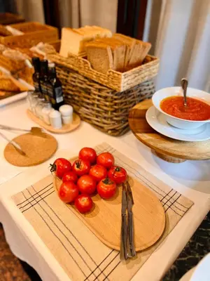 a table with a plate of tomatoes on a cutting board at Ciudad de Castelldefels in Castelldefels
