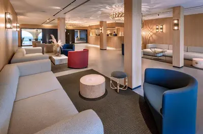 a lobby with couches and chairs and a table at Hotel Playafels in Castelldefels