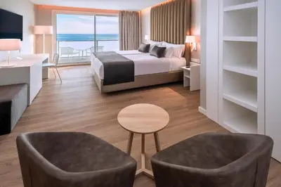 a hotel room with a bed and a view of the ocean at Hotel Playafels in Castelldefels