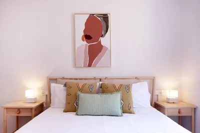 a bedroom with a white bed with two night stands at 22PAR1006 Newly refurbished 2bed apartment in Paral in Barcelona