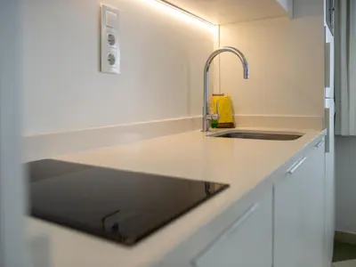 a kitchen with a sink and a counter at Apartamentos Sunway Amapola in Sitges