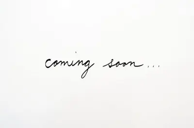 a sign that reads coming soon in black handwriting at Gracia Terrace in Barcelona