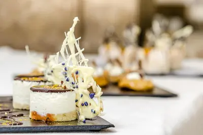 a couple of desserts on a plate on a table at Gran Sol Hotel in San Pol de Mar