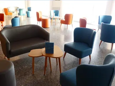 a waiting room with chairs and a couch and a table at Gran Sol Hotel in San Pol de Mar