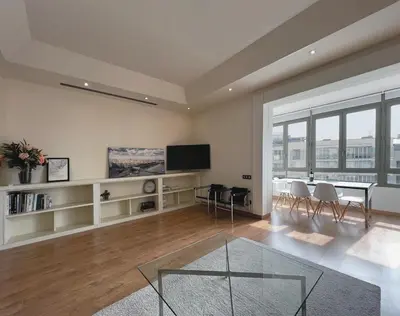 a living room with a dining table and a tv at Stay Unique Apartments Diagonal III in Barcelona