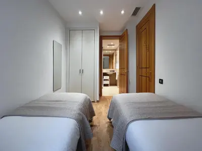 a bedroom with two beds and a hallway at Stay Unique Apartments Diagonal III in Barcelona