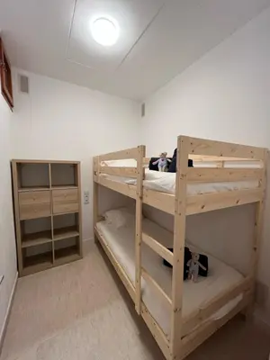 two bunk beds in a room with a ceiling at Apartamento St Zenon in Arenys de Mar