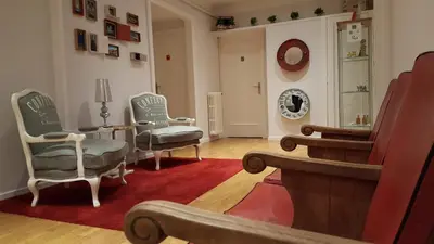 a living room with chairs and a table and a mirror at Petit Hotel in Barcelona