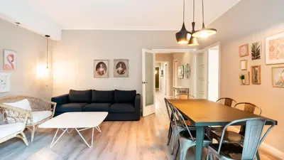 a living room with a couch and a table at Magnificent 4 bedroom apartment in Eixample in Barcelona
