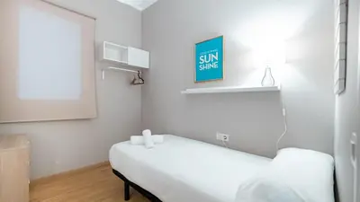 a white room with a bed and a window at Magnificent 4 bedroom apartment in Eixample in Barcelona