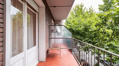 a balcony with a chair and a window at Magnificent 4 bedroom apartment in Eixample in Barcelona