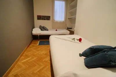 a small room with two beds and a window at Barcelona4Seasons II in Barcelona