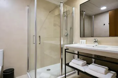 a bathroom with a shower and a sink at Vale Suites in Barcelona