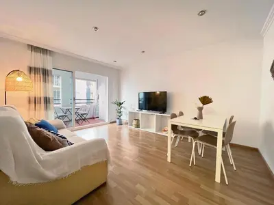 a living room with a couch and a table at Hauzify I Apartament Can Reig in San Pol de Mar