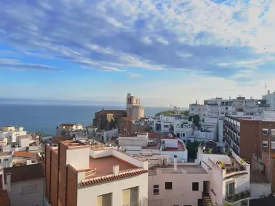 a view of a city with buildings and the ocean at Hauzify I Apartament Can Reig in San Pol de Mar