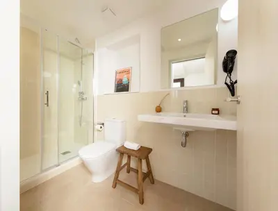 a bathroom with a toilet and a sink and a shower at Som Nit Port Vell in Barcelona