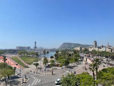 a view of a city with a street and a river at Som Nit Port Vell in Barcelona