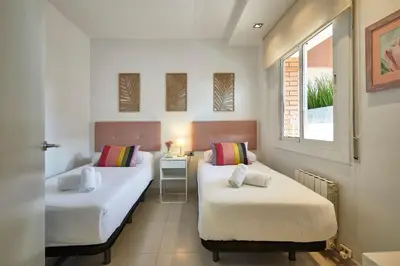 a room with two beds and a window at BBarcelona Diputació Flat in Barcelona