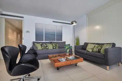 a living room with a couch and a chair at BBarcelona Diputació Flat in Barcelona