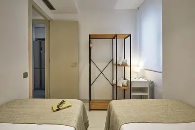 a room with two beds and a mirror at BBarcelona Diputació Flat in Barcelona