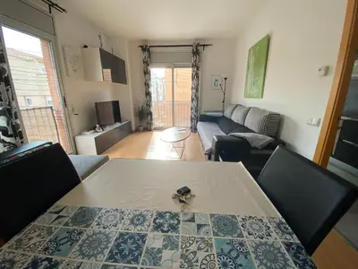 a living room with a table with a pair of scissors on it at Oasis familiar Terrassa in Terrassa