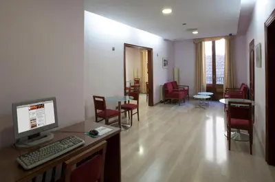 an office with a computer on a desk and chairs at Alba Hotel in Barcelona