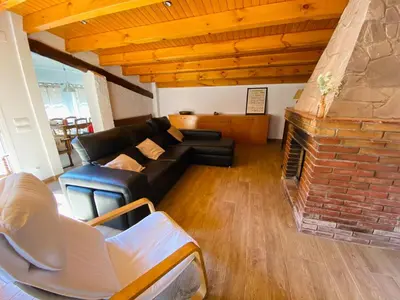 a living room with a couch and a fireplace at Refugio en el Parque natural del Montseny in El Brull