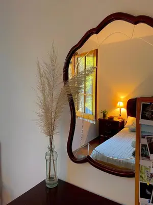 a bedroom with a large mirror on the wall at Refugio en el Parque natural del Montseny in El Brull