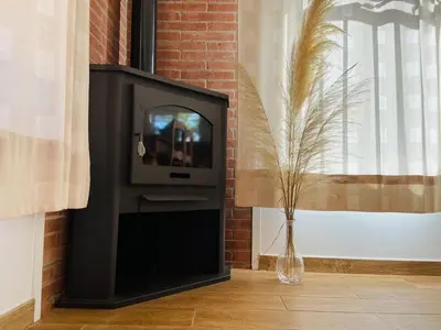 a tv in a wall with a vase next to a window at Refugio en el Parque natural del Montseny in El Brull