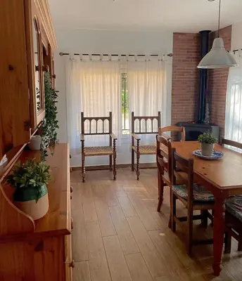 a kitchen and dining room with a table and chairs at Refugio en el Parque natural del Montseny in El Brull