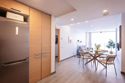 a kitchen and dining room with a table and chairs at Sweett - Casa Fira in Barcelona