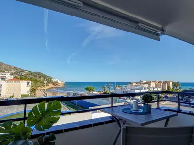a balcony with a table and a view of the ocean at The Beach Studio by Hello Homes Sitges in Sitges