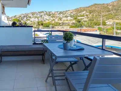 a blue table and chairs on a balcony at The Beach Studio by Hello Homes Sitges in Sitges
