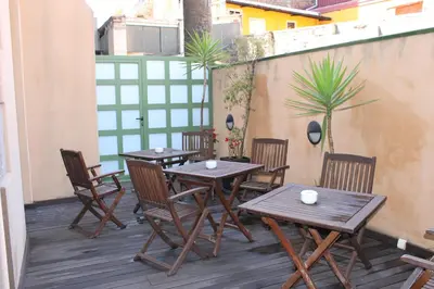 a group of tables and chairs on a balcony at Hotel Sant Agustí in Barcelona