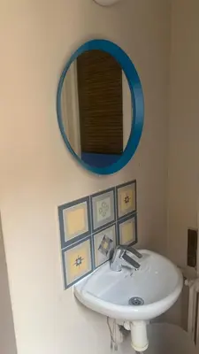 a bathroom with a white sink and a blue mirror at Somnio Hostels in Barcelona