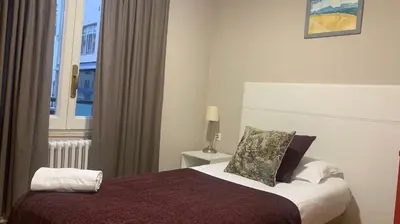 a hotel room with a bed with a window at Somnio Hostels in Barcelona