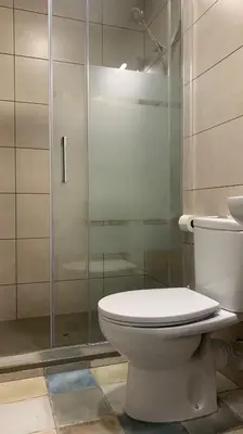 a bathroom with a toilet and a glass shower at Somnio Hostels in Barcelona