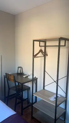a room with a desk and a table with a chair at Somnio Hostels in Barcelona