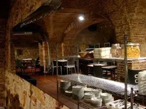 a large kitchen with tables and chairs in a room at Roma Reial in Barcelona