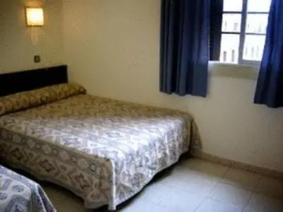 a small bedroom with a bed and a window at Roma Reial in Barcelona